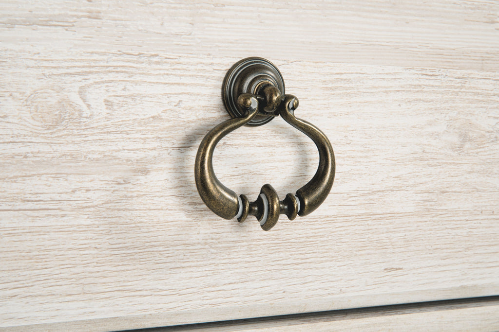 Light beige cabinet drawer pull with antique bronze ring handle