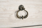 Light beige cabinet drawer pull with antique bronze ring handle