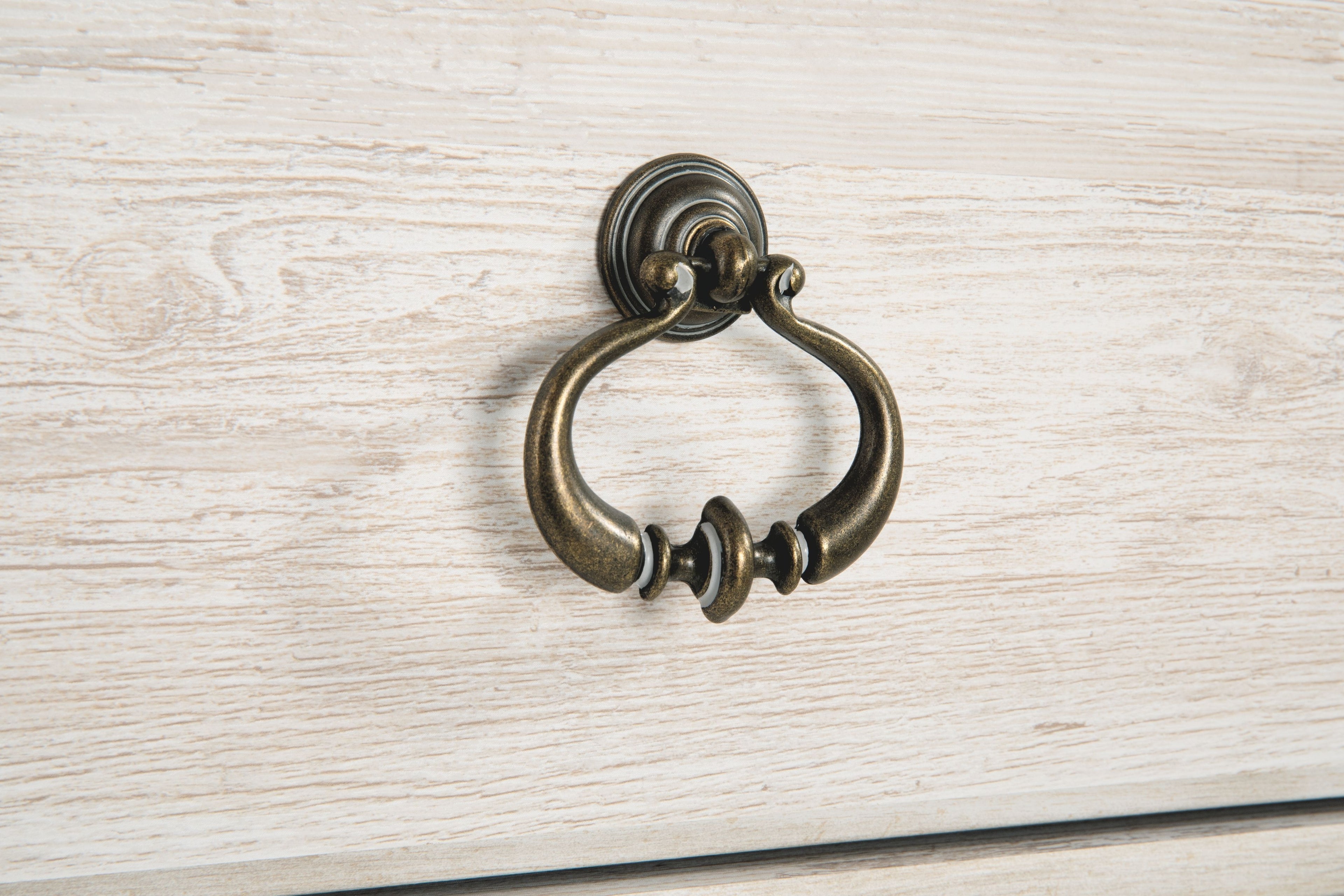 Light beige cabinet drawer pull with antique bronze ring handle