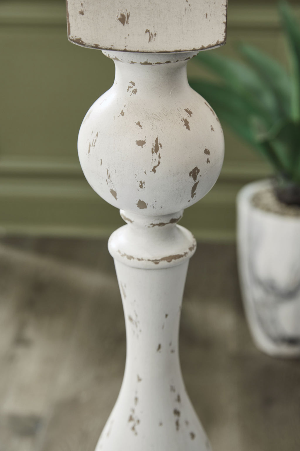 Close-up of distressed white lamp body with brown speckled flecks