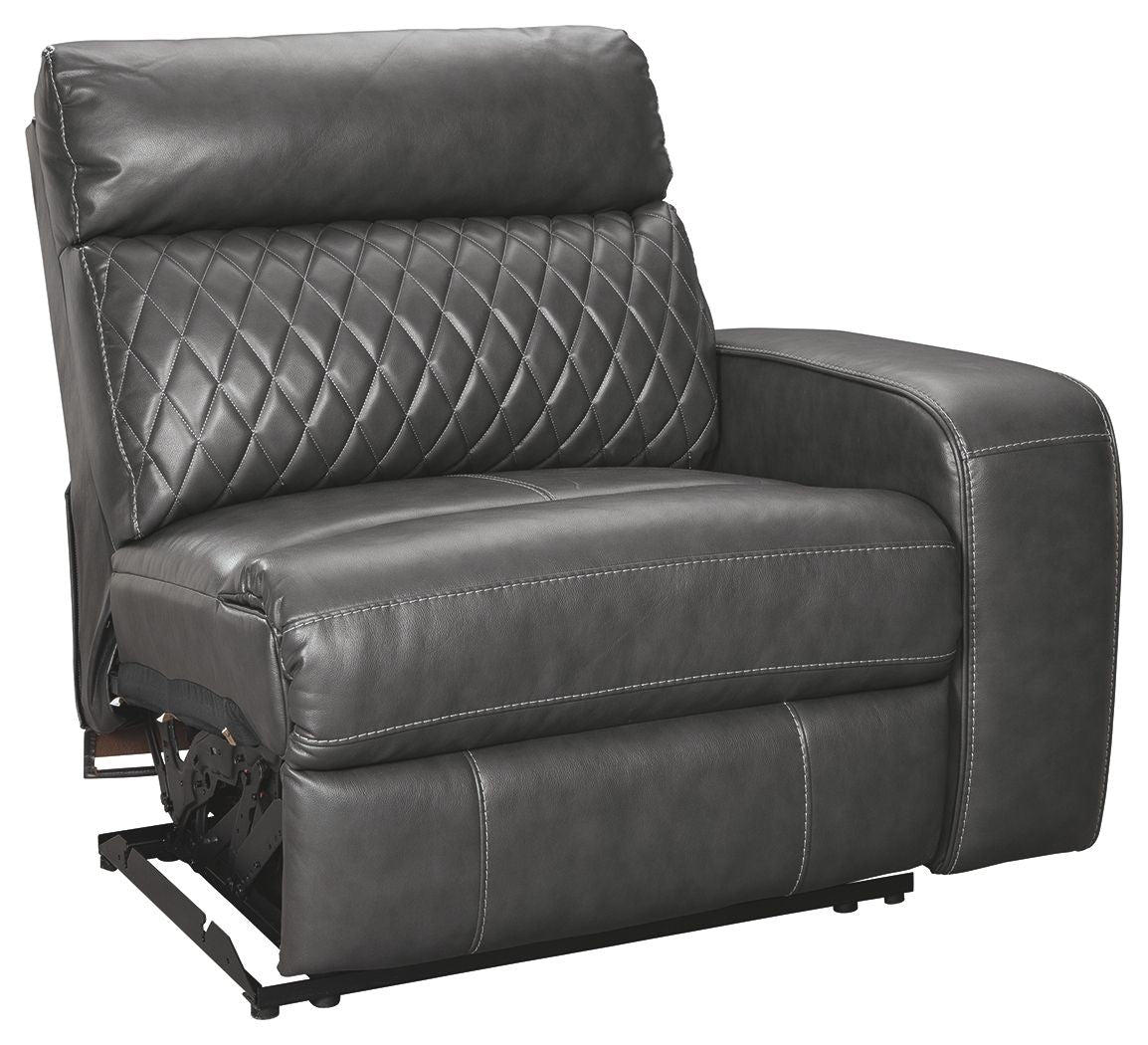 Gray power recliner chair with diamond-quilted back and padded armrests, metal base