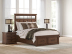 Dark brown platform storage bed with upholstered headboard and drawer base, styled with bedding