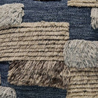 Pillow cover closeup: blue and cream textured patchwork with fringe trim