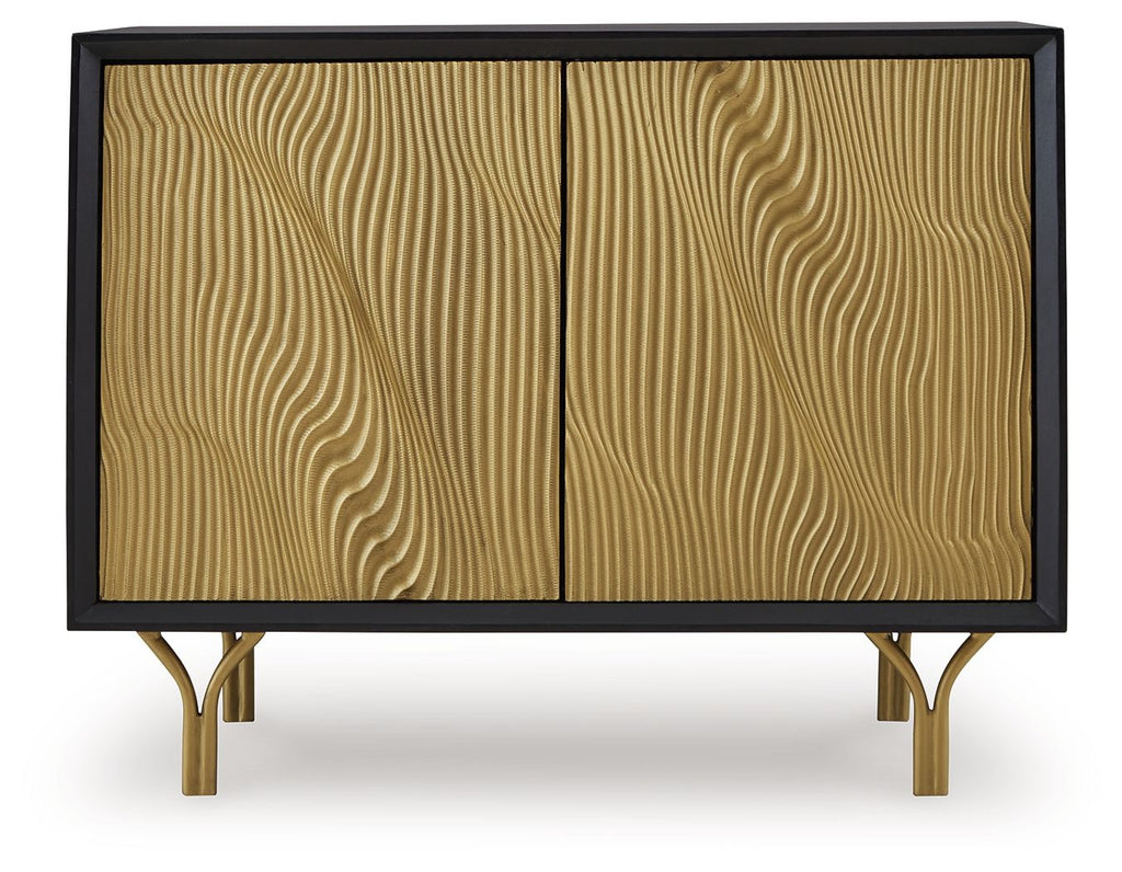Accent cabinet with two gold fluted doors and dark frame, gold-toned legs visible
