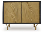 Accent cabinet with two gold fluted doors and dark frame, gold-toned legs visible