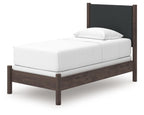 Upholstered panel bed with white mattress and dark gray headboard, dark brown wood frame