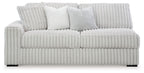 Light gray sofa with ribbed upholstery, rounded arms, and three back cushions