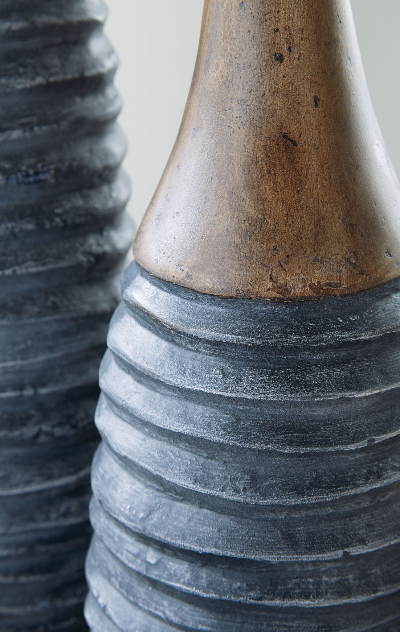 Close-up of ribbed vase body in antique gray-blue with brown speckled rim