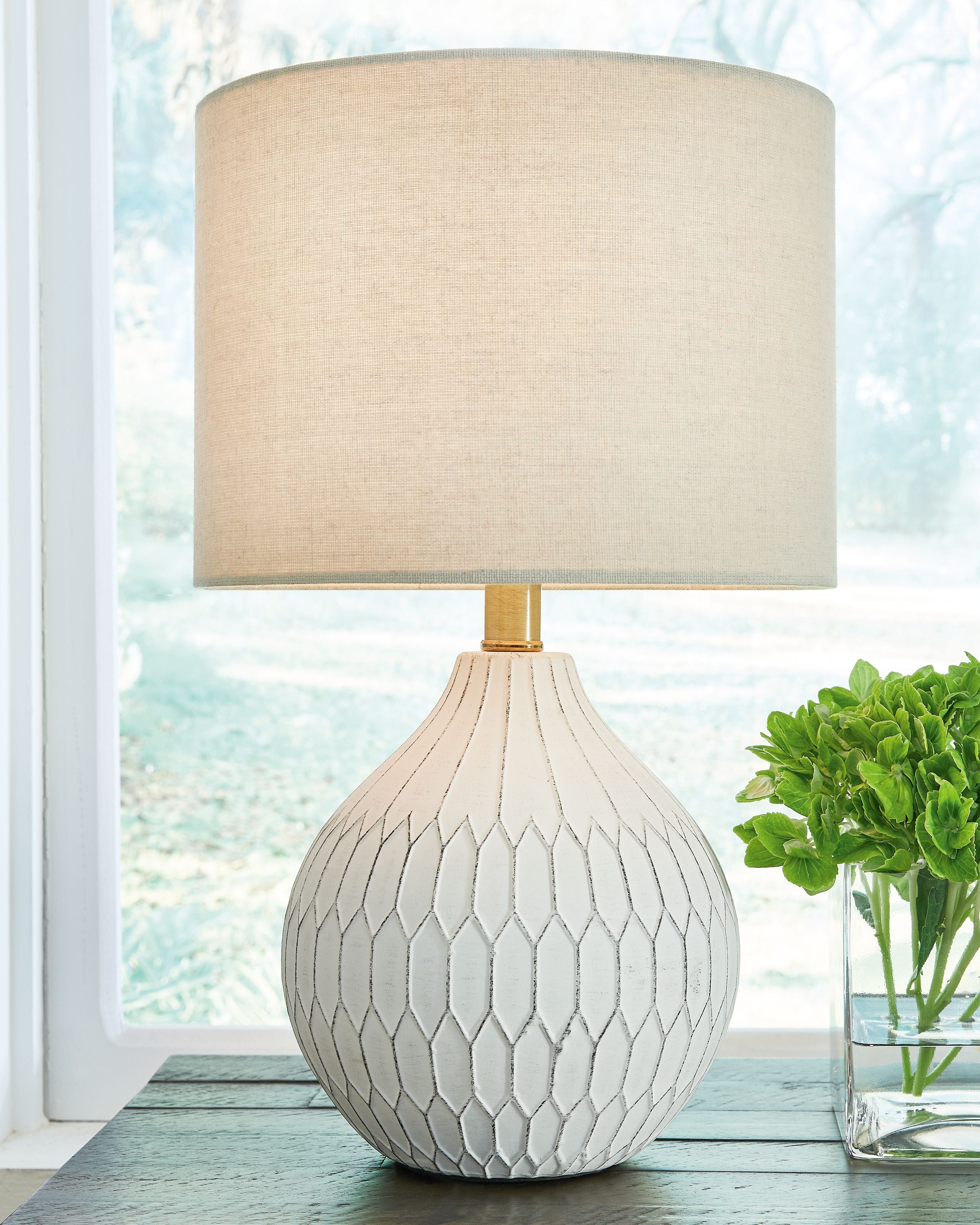 Ceramic table lamp with white fabric shade and white textured diamond base with brass neck