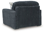Dark gray chair and a half with thick ribbed upholstery and rounded arms