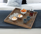 Brown wooden serving tray holding cups, a teapot, and boiled egg halves.