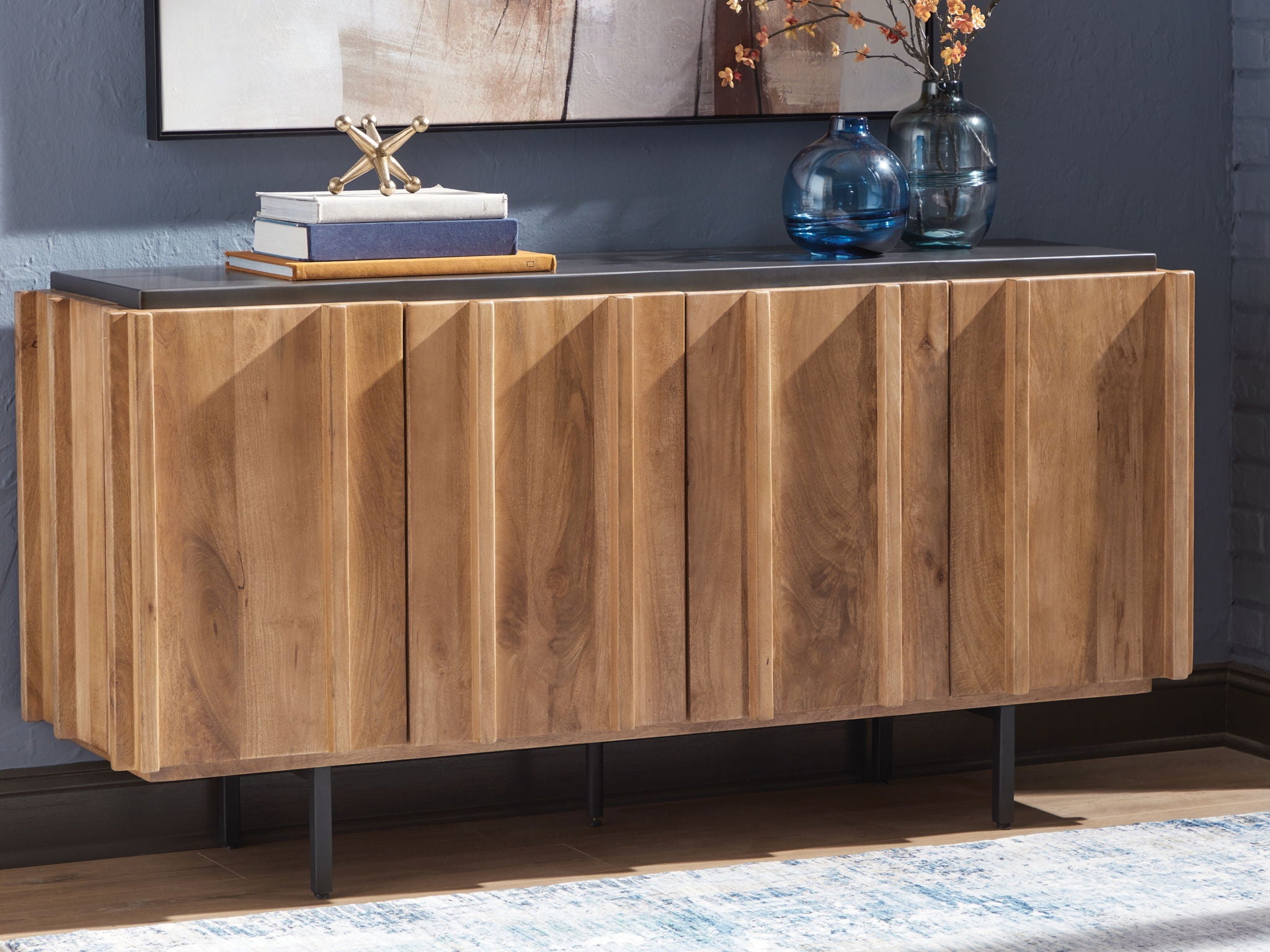 Wood accent cabinet with charcoal top and four paneled doors on black legs