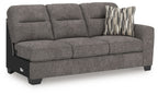 Graphite gray fabric sofa with chaise, three seat cushions, striped accent pillow