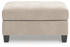 Taupe upholstered ottoman with wide seat cushion and dark tapered legs