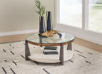 Round cocktail table with glass top, lower shelf, and dark wooden legs