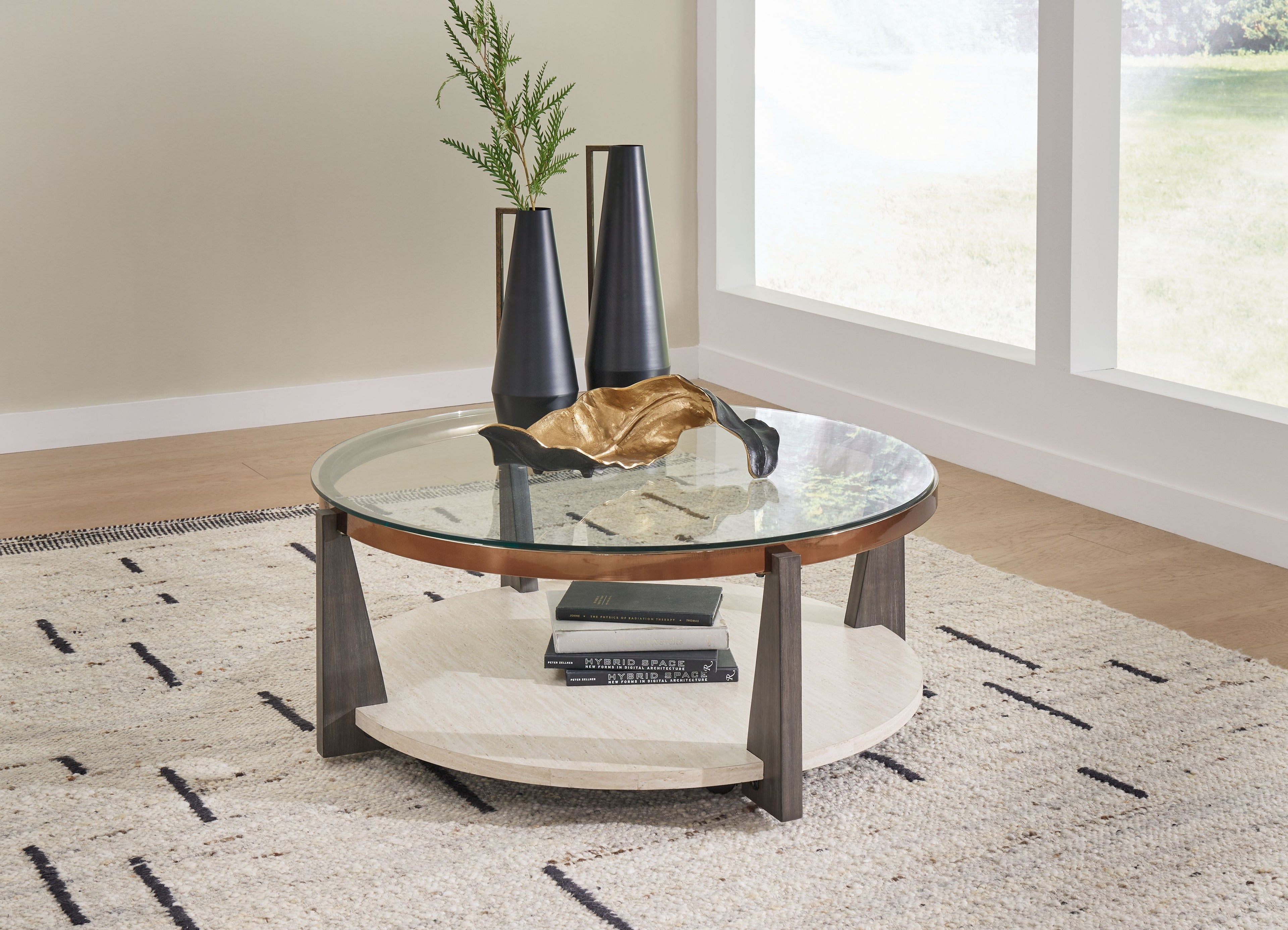 Round cocktail table with glass top, lower shelf, and dark wooden legs
