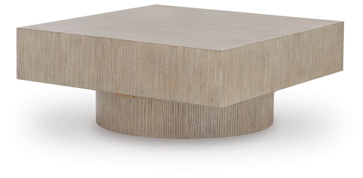 Light brown square table with low round pedestal base