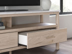 Light wood TV stand drawer front with recessed handle and open storage