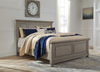 Light gray upholstered king bed frame with pillows and folded throw blanket