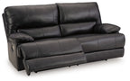 Black leather-look sofa with padded arms and tufted back cushions