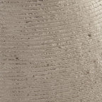Beige ceramic vase surface detail with horizontal ribbing and speckles