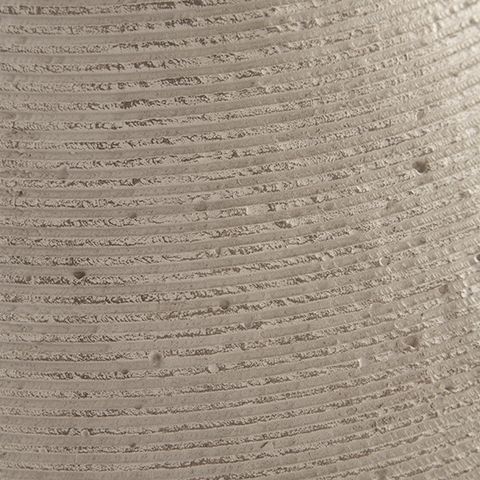 Beige ceramic vase surface detail with horizontal ribbing and speckles