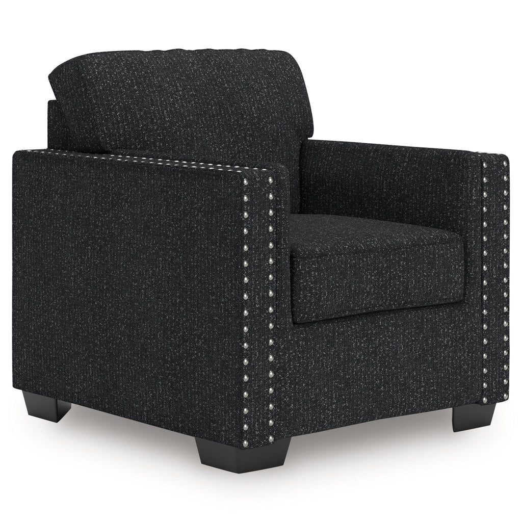 Dark charcoal upholstered armchair with padded back, wide arms, and silver nailhead trim.