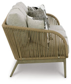 Beige woven sofa with light gray cushions and assorted patterned accent pillows