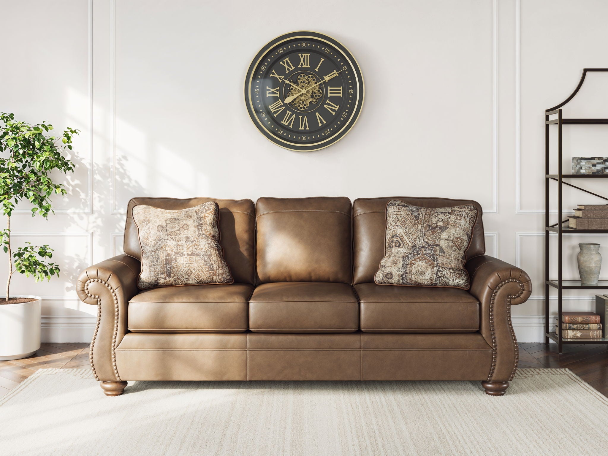 Chasemore sofa in tan with two patterned accent pillows and turned wooden legs