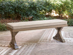 Cushioned outdoor bench with beige top and dark wood base, long bench style