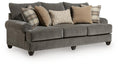Gray queen sofa sleeper with tufted arms and plaid and neutral accent pillows