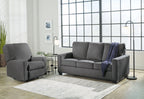 Dark gray sofa set with matching armchair, blue throw draped over the sofa