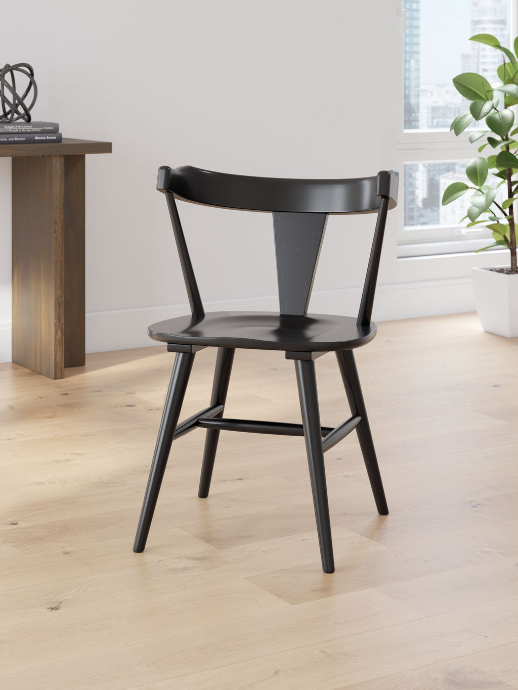 Dining room side chair in black with curved back and seat, four tapered legs