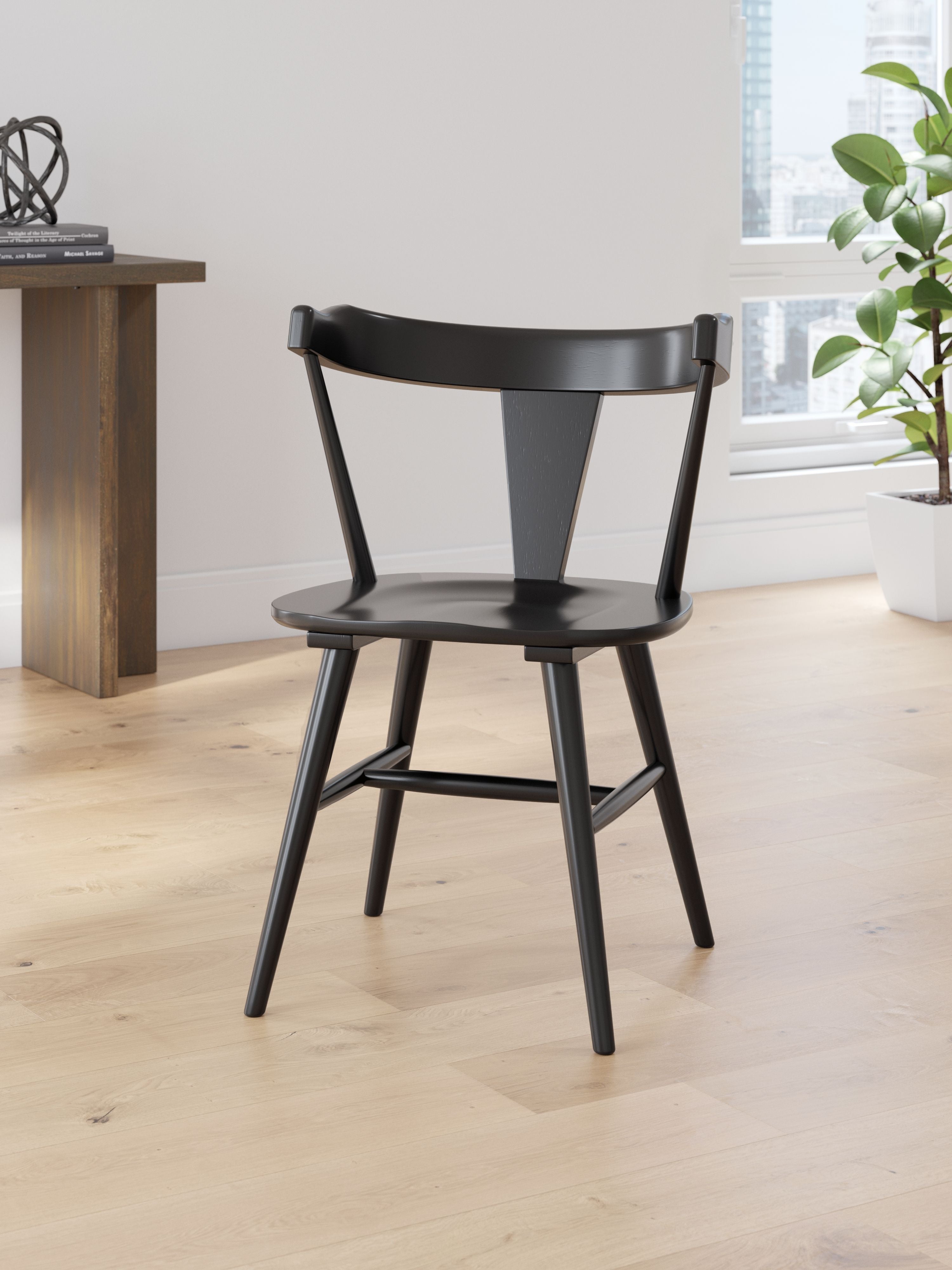 Dining room side chair in black with curved back and seat, four tapered legs