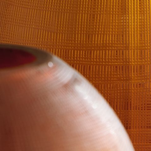 Embersen vase close-up texture, dark brown woven pattern with glossy highlights