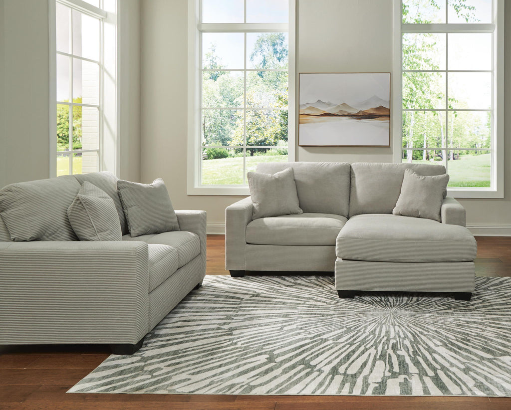 Light gray sofa set with chaise ottoman and loveseat, square arms and throw pillows