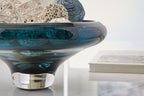 Teal blue glass bowl with dark rim, side view