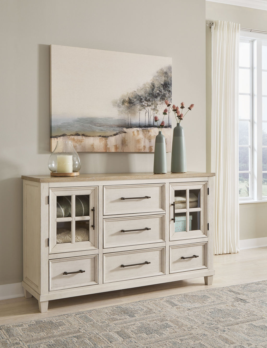 Antique-style dresser in antique white with brown top, glass-front doors and drawers