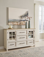 Antique-style dresser in antique white with brown top, glass-front doors and drawers