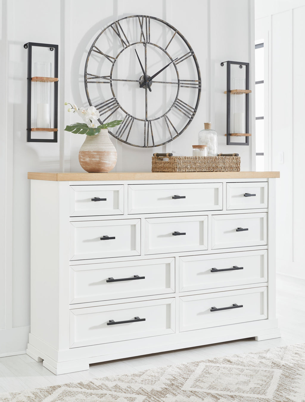 White dresser with black bar handles and natural wood top, front-facing drawers.