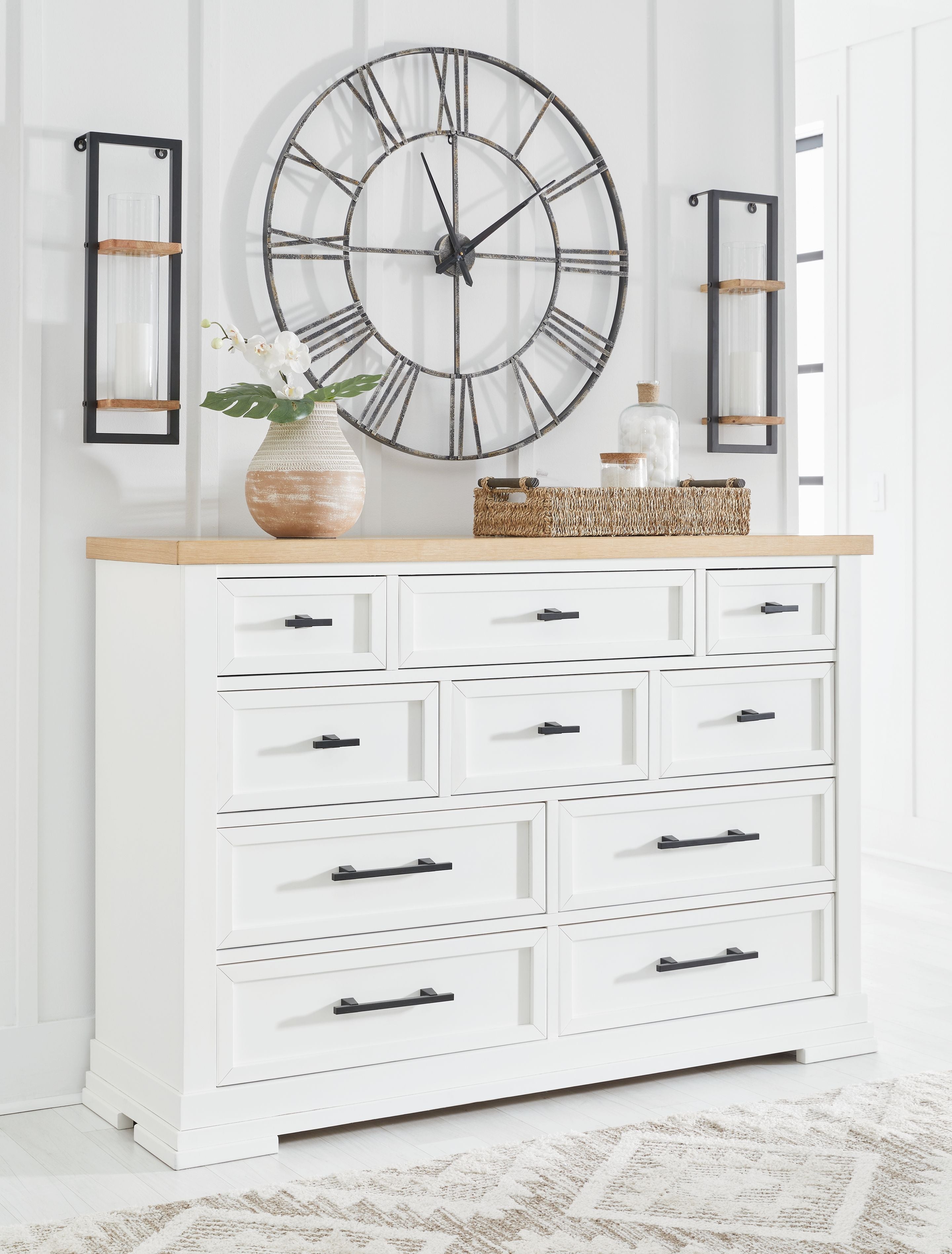 White dresser with black bar handles and natural wood top, front-facing drawers.