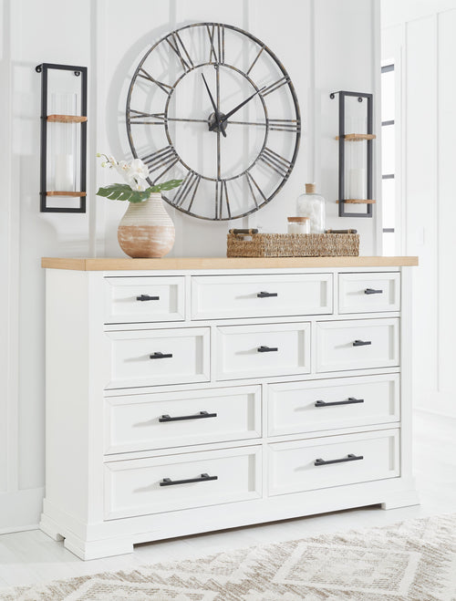 White dresser with black bar handles and natural wood top, front-facing drawers.