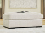 Upholstered ottoman with light beige linen fabric and low dark wood legs