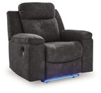 Charcoal zero-wall recliner angled view with padded headrest, armrests, and seat/leg rest