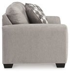 Gray flannel loveseat side view with patterned back pillow