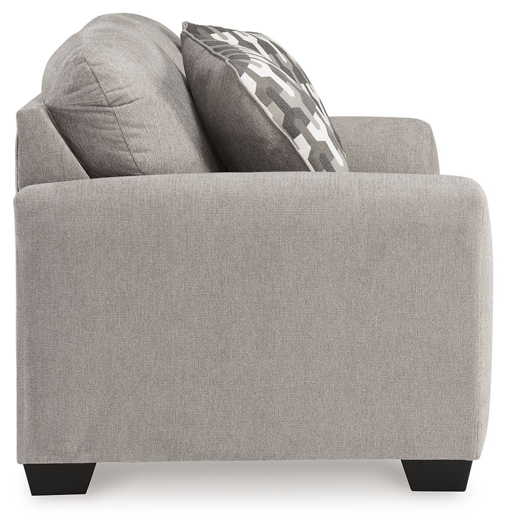 Gray flannel loveseat side view with patterned back pillow