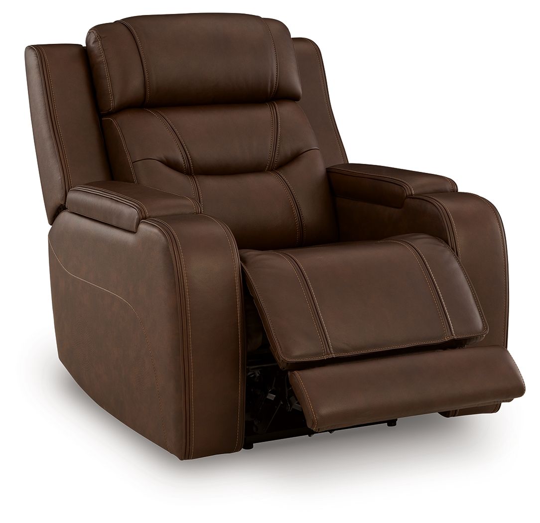 Power recliner with dark brown upholstery, padded arms, and raised footrest