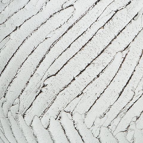 White vase textured surface close-up with deep vertical grooves