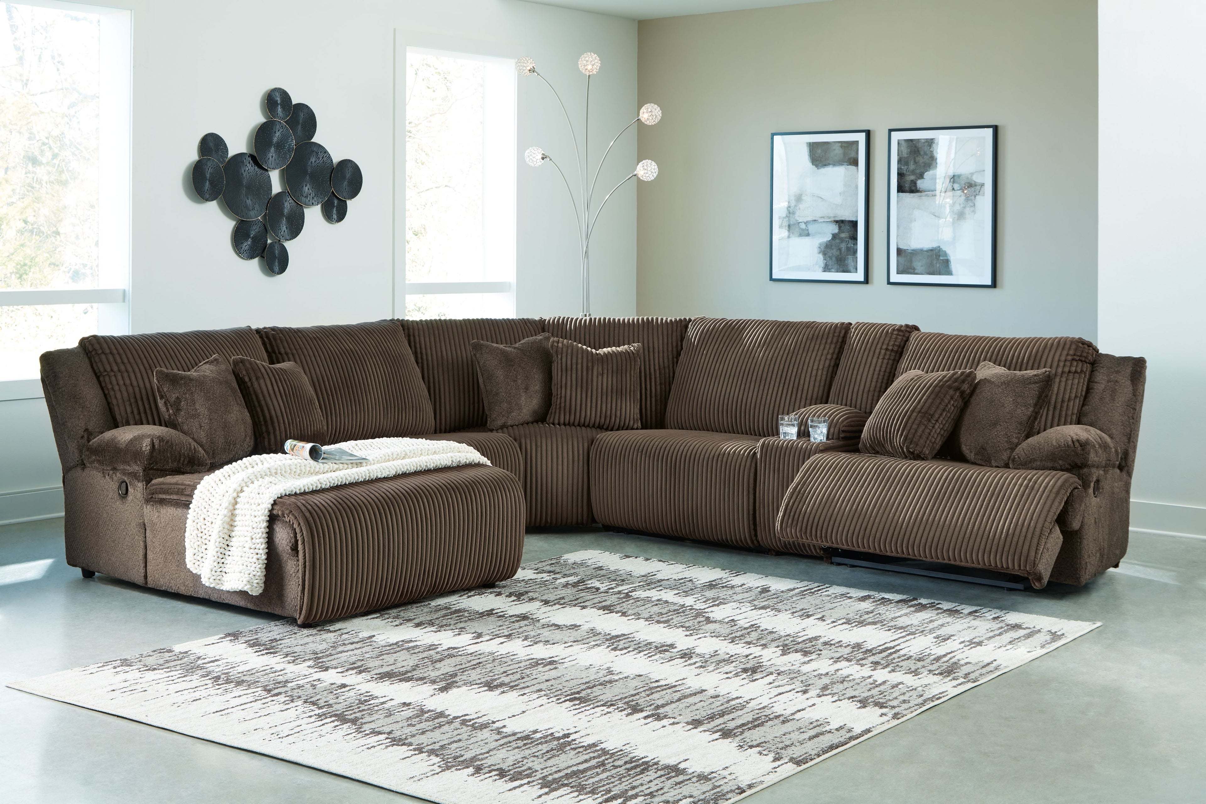 Dark brown reclining sectional sofa with chaise and textured striped fabric