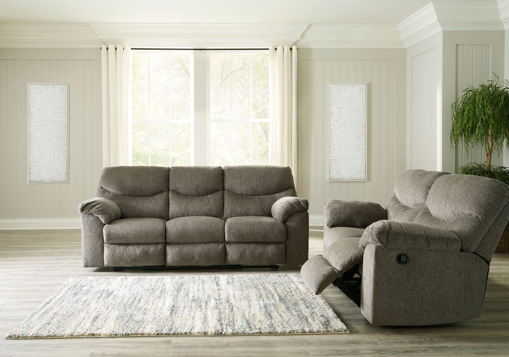Taupe fabric sofa with matching recliner chair on an open seating rug